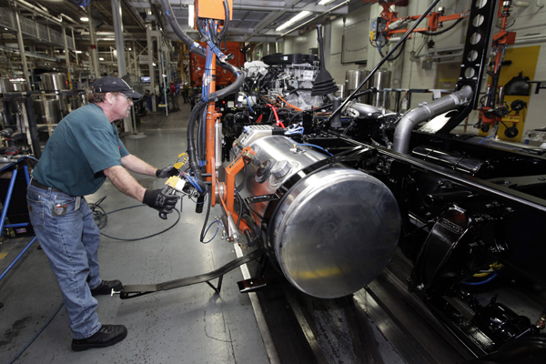 Thomas Warren installs a fuel cell on a Freightliner truck at a plant in Cleveland, N.C. (AP/Chuck Burton)