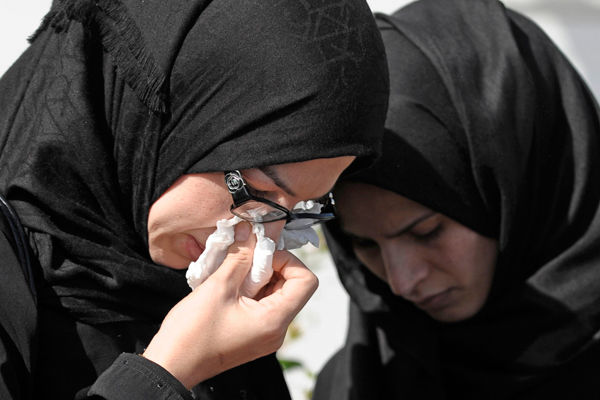 Women in mourning cry outside a memorial service for Shaima Alawadi in Lakeside, Calif. March 27, 2012. (Reuters/Denis Poroy)