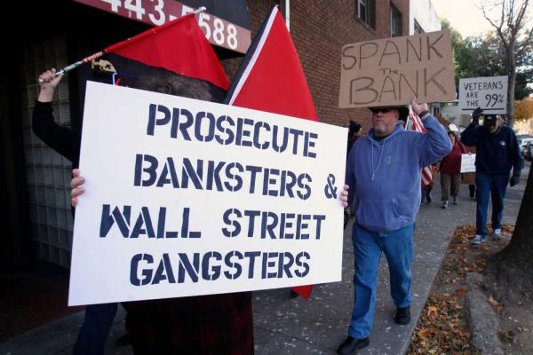 Members of Occupy Sacramento march through downtown Sacramento as part of the "National Day of Action to Stop and Reverse Foreclosures," Tuesday, Dec. 6, 2011 (AP/Rich Pedroncelli)