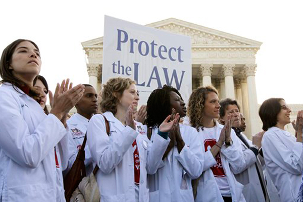 Doctors and medical students supporting President Obama's health care reform law gather in front of the Supreme Court on Monday. (AP/Charles Dharapak)