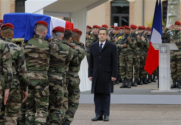 French President Nicolas Sarkozy stands by soldiers carrying a coffin during a ceremony honoring the three soldiers killed by a suspect identified as Mohammad Merah, who is also suspected in the killings of three Jewish children and a rabbi, Wednesday, March 21, 2012 in Montauban, southwestern France (AP Photo/Jacques Brinon)