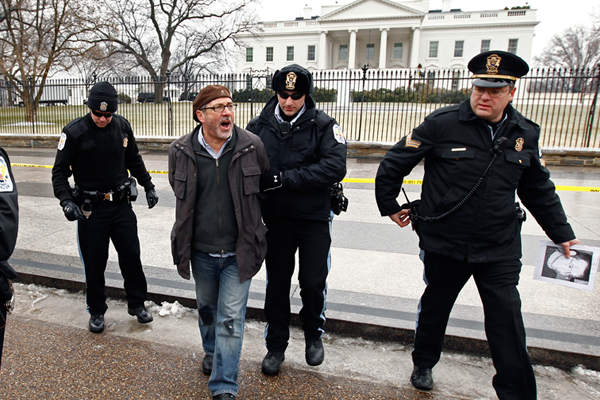A protester is arrested at the White House in January, 2011. (AP/Kevin Lamarque)