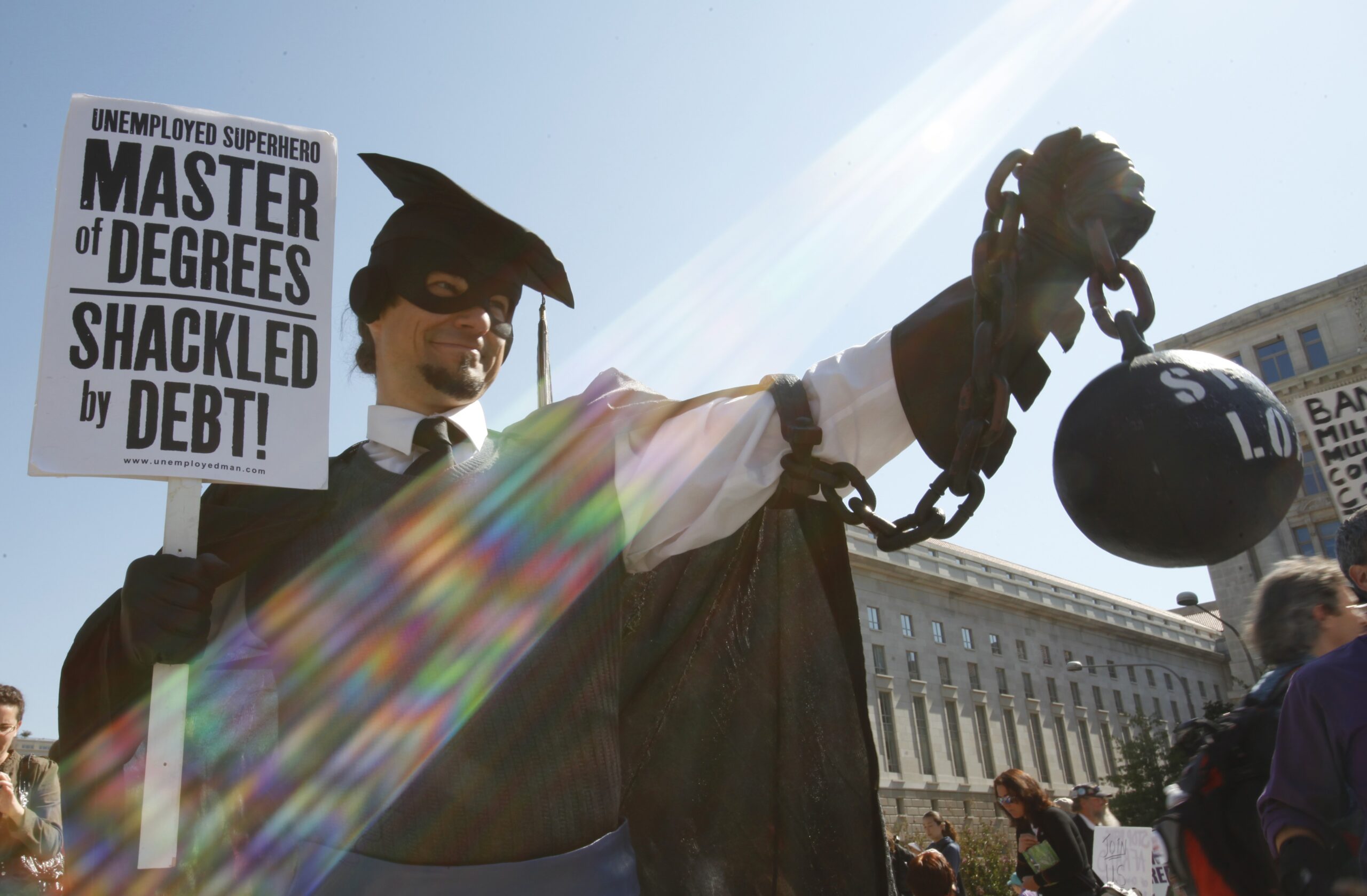 Gan Golan holds a ball and chain representing his college loan debt, during Occupy DC activities in Washington, on Oct. 6, 2011. (AP/Jacquelyn Martin)