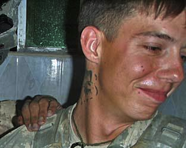 In a cropped version of a photo released by the LA Times, a soldier from the Army's 82nd Airborne Division with the body of an Afghan insurgent killed while trying to plant a roadside bomb (Los Angeles Times)