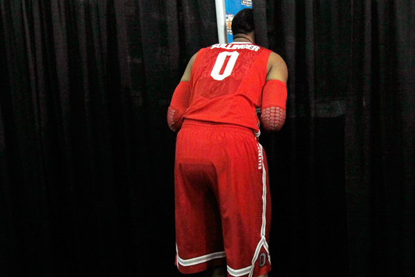 Ohio State forward Jared Sullinger peeks through a curtain while teammates participate in interviews in New Orleans on March 29. (AP/Gerald Herbert)