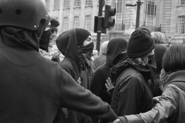 A Black bloc protest in London. (<span about='http://www.flickr.com/photos/alightbourne/5613721669/' xmlns:cc='http://creativecommons.org/ns#'><a href='http://www.flickr.com/photos/alightbourne/with/5613721669/' rel='cc:attributionURL' target='_blank'>alightman</a> / <a href='http://creativecommons.org/licenses/by/3.0/' rel='license' target='_blank'>CC BY 3.0</a></span>)