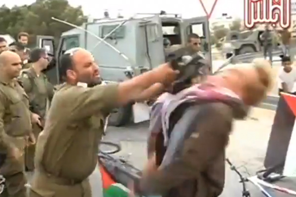 Israeli army Lieutenant-Colonel Shalom Eisner uses his M-16 rifle to strike Danish pro-Palestinian protester Andreas Las during a protest near Jericho on April 14.