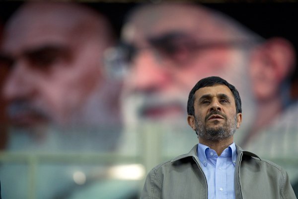 Iran's President Mahmoud Ahmadinejad stands beneath a portrait of Supreme Leader Ayatollah Ali Khamenei. (Reuters/Caren Firouz)