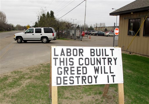 A pro-labor sign is posted outside the entrance of the American Crystal Sugar Co. plant in Moorhead, Minn., Monday, April 2, 2012 (AP Photo/Dave Kolpack)