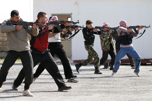 Syrian rebels aim during a weapons training exercise outside Idlib, Syria. (AP)