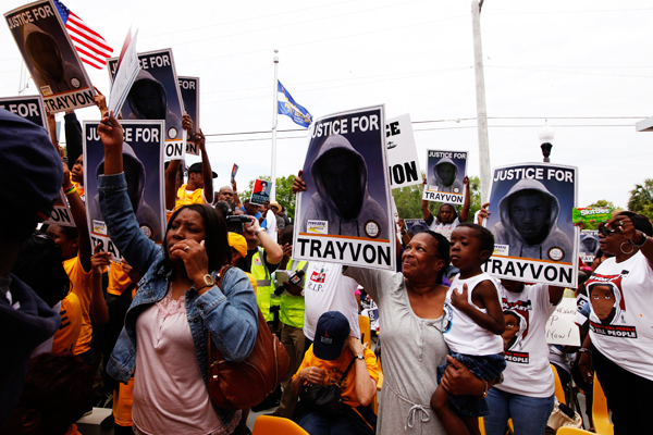 Demonstrators hold signs during a march to the front of the Sanford Police Department for Trayvon Martin in Sanford, Florida, March 31, 2012 (Reuters/Lucas Jackson)