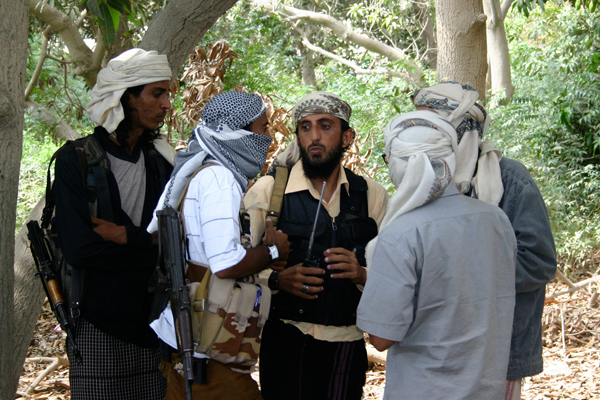 Members of a group affiliated with Al-Qaida talk in the southern Yemeni city of Zinjibar January 21, 2012 (Reuters)