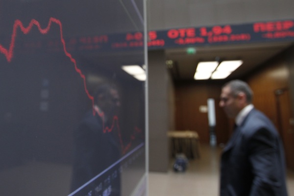 A man is reflected in the chart with stock prices at the Greek Stock Exchange in Athens, Monday, May 14, 2012. (AP Photo/Petros Giannakouris) (AP)