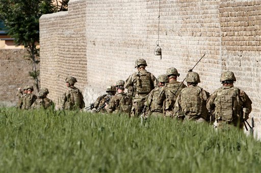U.S. Army soldiers respond after a suicide attack on the US..-led provincial reconstruction team (PRT) compound in the Behsood district of Jalalabad, east of Kabul Afghanistan, on Sunday, April 15, 15 2012. (AP Phot/Rahmat Gul)