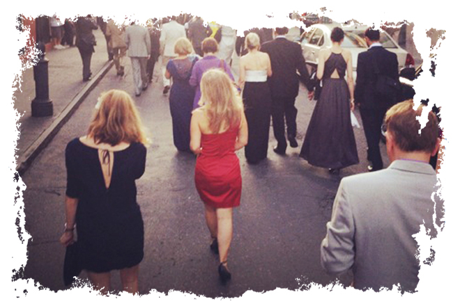 The author in a red dress in a Second Line processional
through the French Quarter. (Laurence Kretchmer)