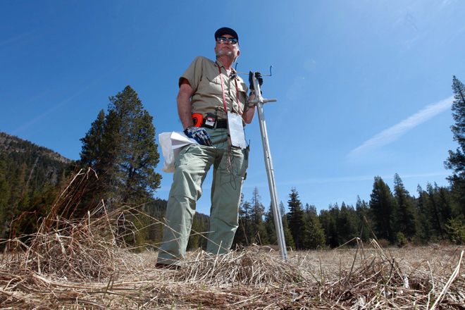 Frank Gehrke, chief of snow surveys for the Department of Water Resources, stands in a snow-free meadow at Echo Summit, Calif. Warm spring weather, combined with lower then normal precipitation, caused the statewide snowpack water content to be only 40 percent of normal for this time of year. (AP/Rich Pedroncelli)