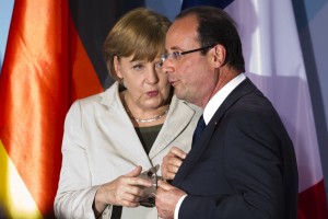 In this May 15, 2012 file photo, German Chancellor Angela Merkel, left, talks to new French President Francois Hollande in Berlin. (AP Photo/Markus Schreiber, File)