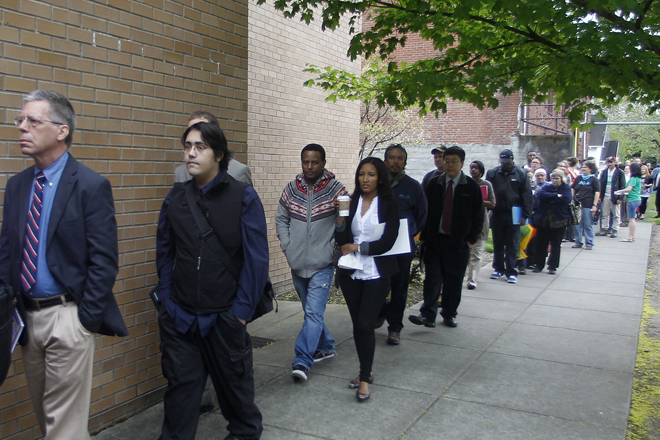 Job seekers wait in line during a job fair in Portland, Ore., on April 24. (AP/Rick Bowmer)