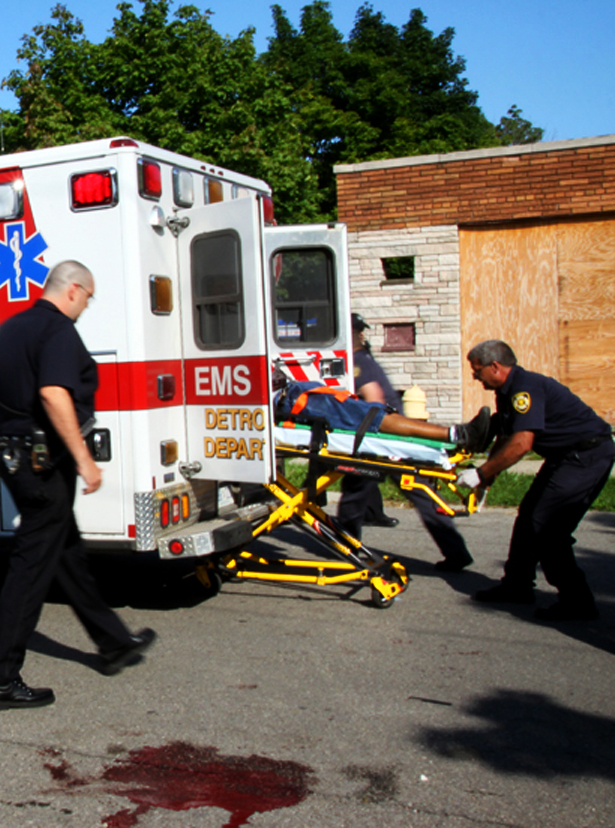 Medics rush a fatally wounded shooting victim to the hospital at Morang and Somerset in Detroit. (Amber Hunt)