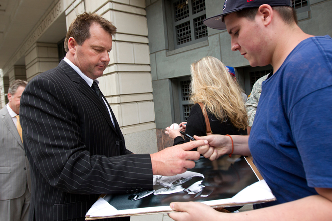 Roger Clemens signs autographs as he leaves federal court on June 5. (AP/Manuel Balce Cenata)