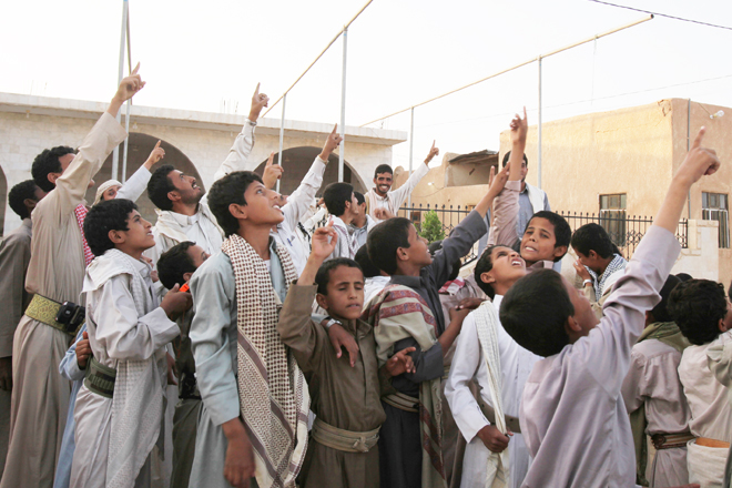Members of the Abida tribe point to the sky as they look for drone aircraft over Wadi Abida, in the eastern Yemeni province of Maarib. (Reuters/Khaled Abdullah)