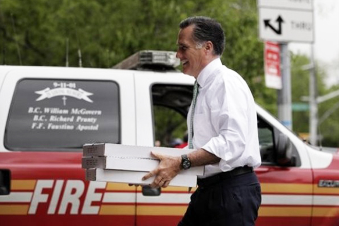 Mitt Romney carries boxes of pizza for firefighters at Engine 24, Ladder 5 in New York on May 1. (AP/Jae C. Hong)