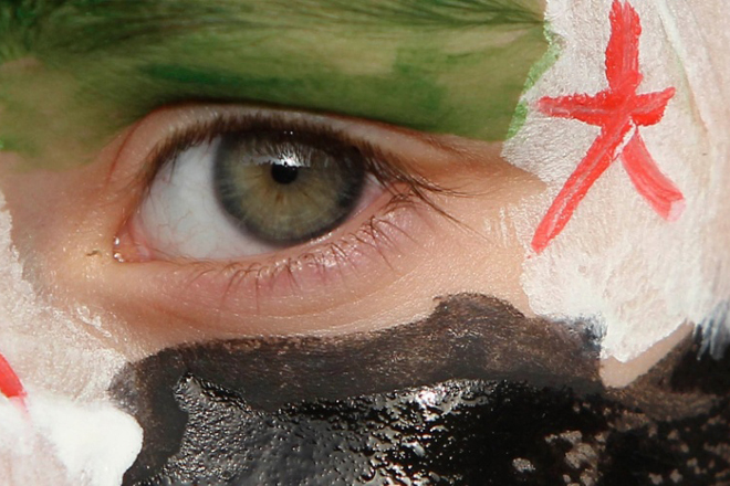 A boy with his face painted in the colours of the Syrian opposition flag takes part in a demonstration against Syria's President Bashar al-Assad. (Reuters/Ali Jarekji)