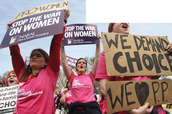 Erica Moses, 21, of Bethlehem, Pa., left, Rachel Graf Evans, 20, of Westtown Pa., and Hope Rehak, 21, of Chicago, take part in a rally in support of Planned Parenthood,  Thursday, April 7, 2011, on the National Mall in Washington. (AP/Jacquelyn Martin)