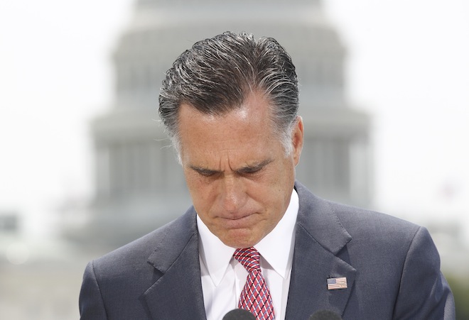 With the Capitol in the background, Republican presidential candidate, former Massachusetts Gov. Mitt Romney pauses while speaking about the Supreme Court's health care ruling, Thursday, June 28, 2012, in Washington. (AP/Charles Dharapak)