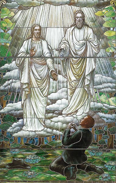 A stained glass window showing Joseph Smith's First Vision (Wikipedia)