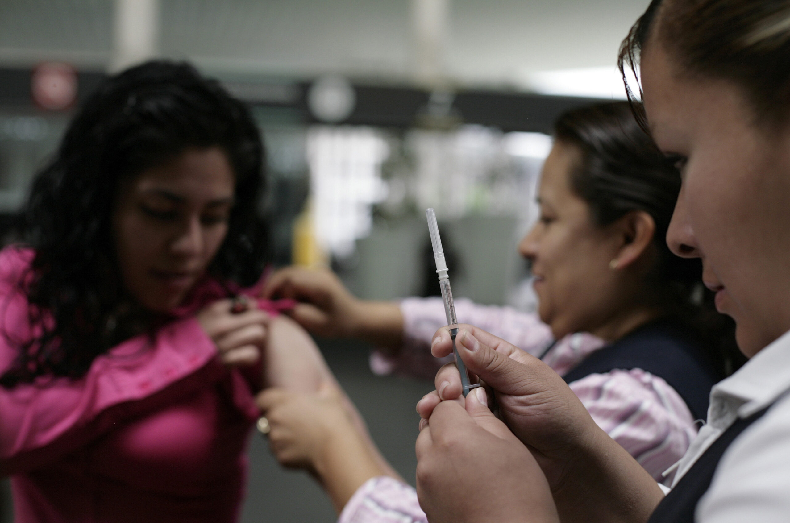 Health workers prepare a passenger for a vaccination against measles at the Benito Juarez international airport in Mexico City. (Reuters)