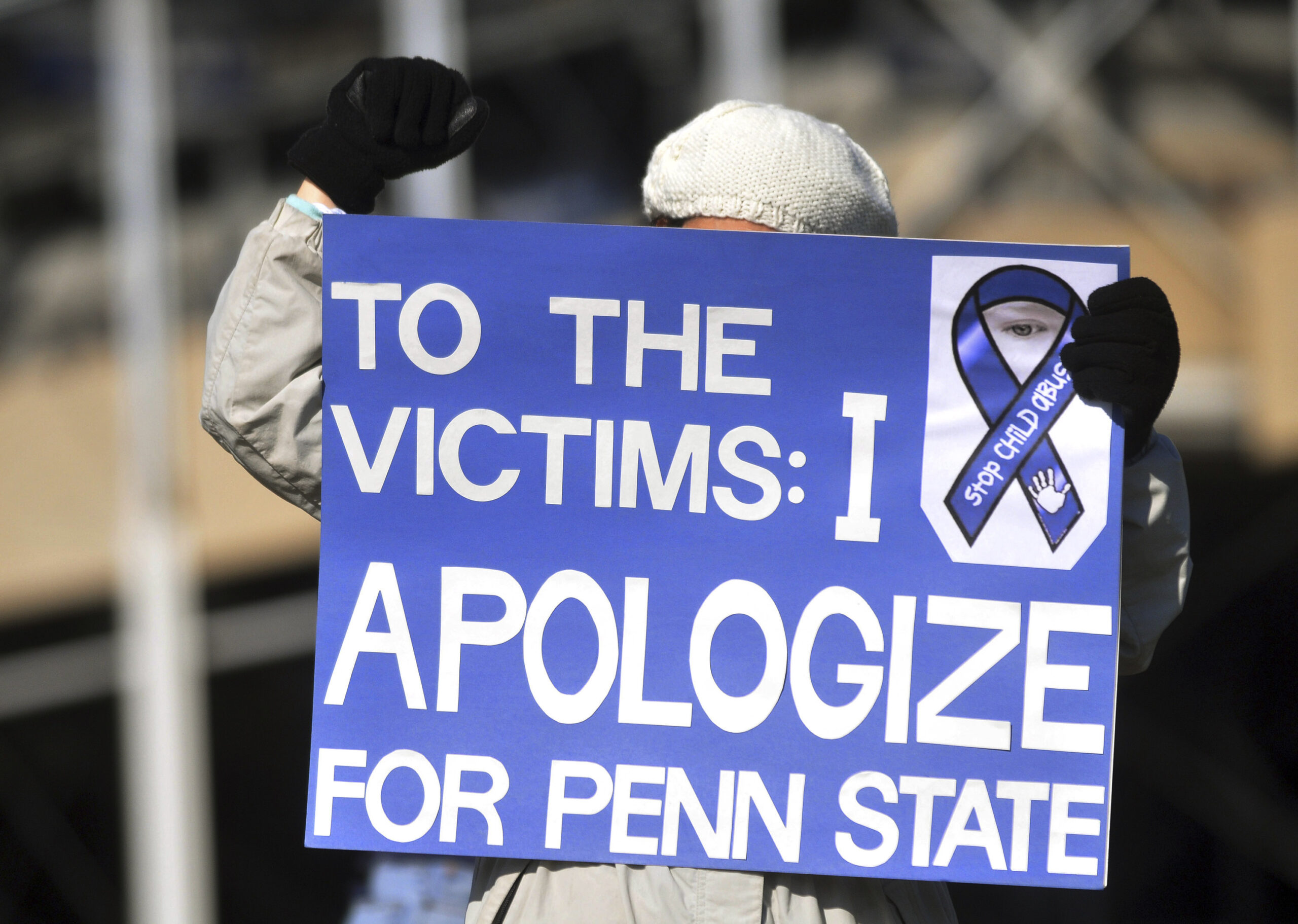 An unidentified protestor stands outside Beaver Stadium prior to the  football game between Nebraska and Penn State last November. (Reuters/Pat Little)