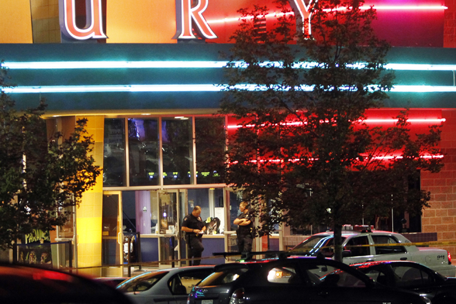 Police are pictured outside of a movie theatre where as many as 12 people were killed in Aurora, Colo. (AP Photo/Ed Andrieski) (Ed Andrieski)