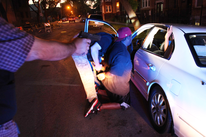 Chicago police arrest a gang member on an outstanding warrant on June 9. (AP/Robert Ray)