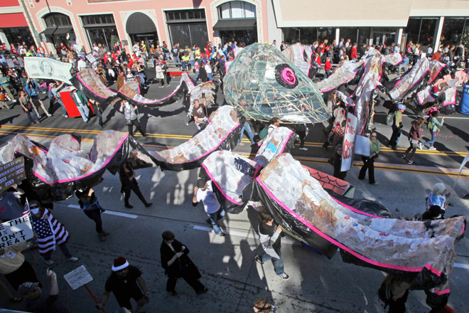Occupy the Rose Parade protesters carry a large "corporate octopus" at the end of the Rose Parade in Pasadena, Calif., Jan. 2, 2012. (AP/Reed Saxon)