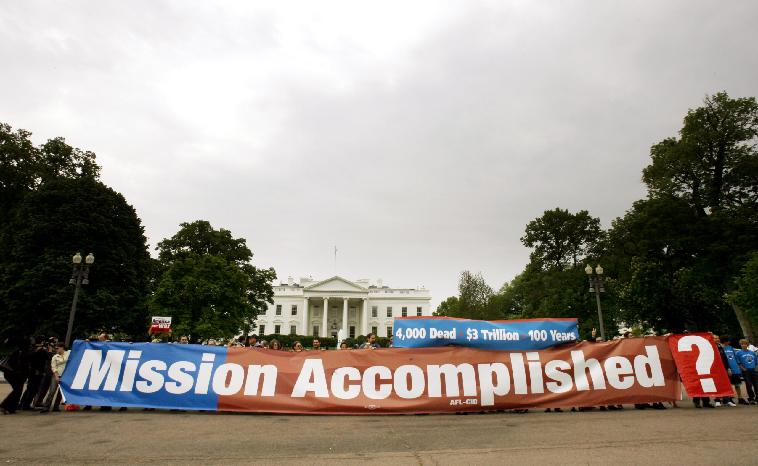 Demonstrators display a replica of "'Mission Accomplished" banner outside of the White House in Washington on Thursday, May 1, 2008. (AP/Jose Luis Magana)