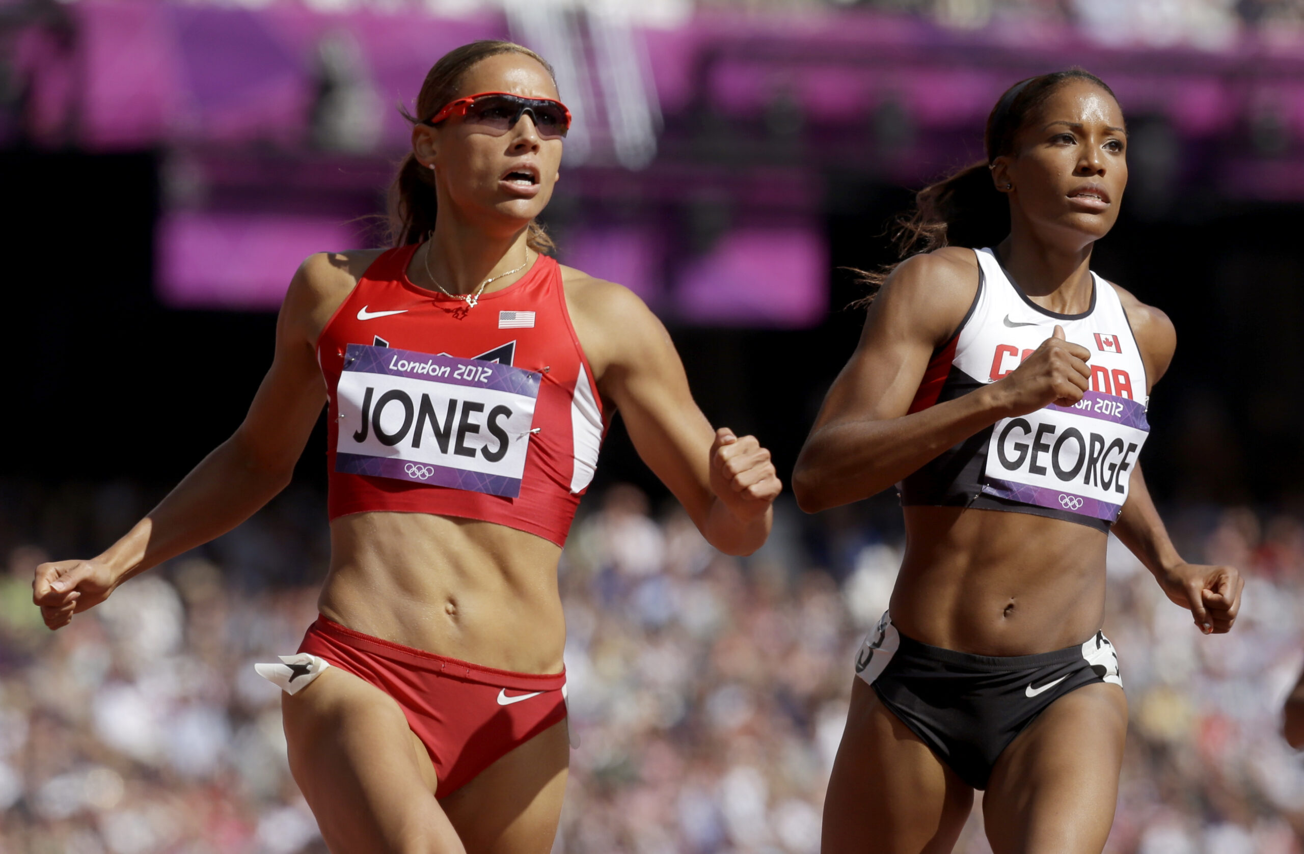 United States' Lolo Jones, left,  Canada's Phylicia George during the athletics in the Olympic Stadium at the 2012 Summer Olympics, London, Monday, Aug. 6, 2012. (AP Photo/Anja Niedringhaus) (AP/Anja Niedringhaus)