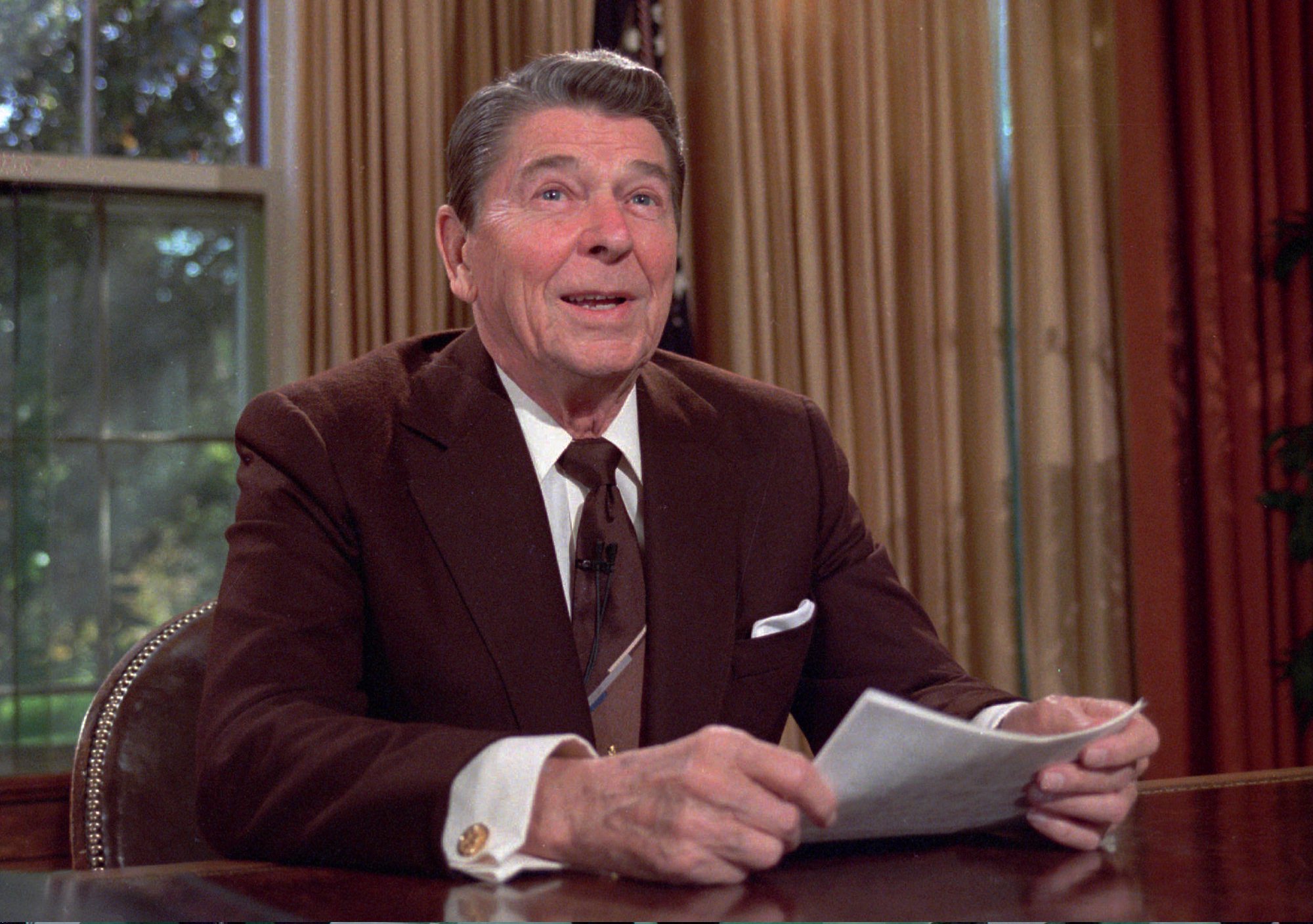 President Ronald Reagan works at his desk in the Oval Office of the White House as he prepares a speech on tax revision  in this May 24,1985 photo. It is reported that Reagan died on Saturday, June 5, 2004 at 93.  (AP Photo/Scott Stewart) (AP)