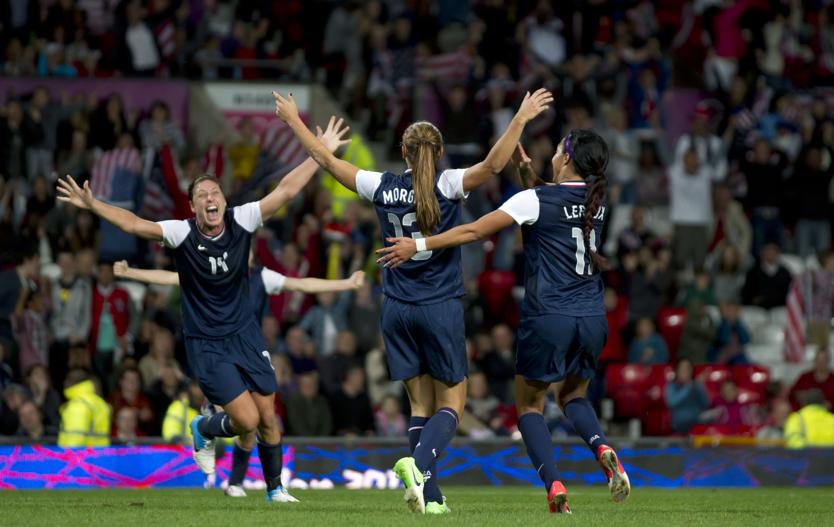 United States' Alex Morgan, center, celebrates with teammates including Abby Wambach, left, and Sydney Leroux after the winning goal was scored past Canada's goalkeeper Erin Mcleod during their semifinal women's soccer match at the 2012 London Summer Olympics, Monday, Aug. 6, 2012, at Old Trafford Stadium in Manchester, England. (AP Photo/) (AP/Jon Super)