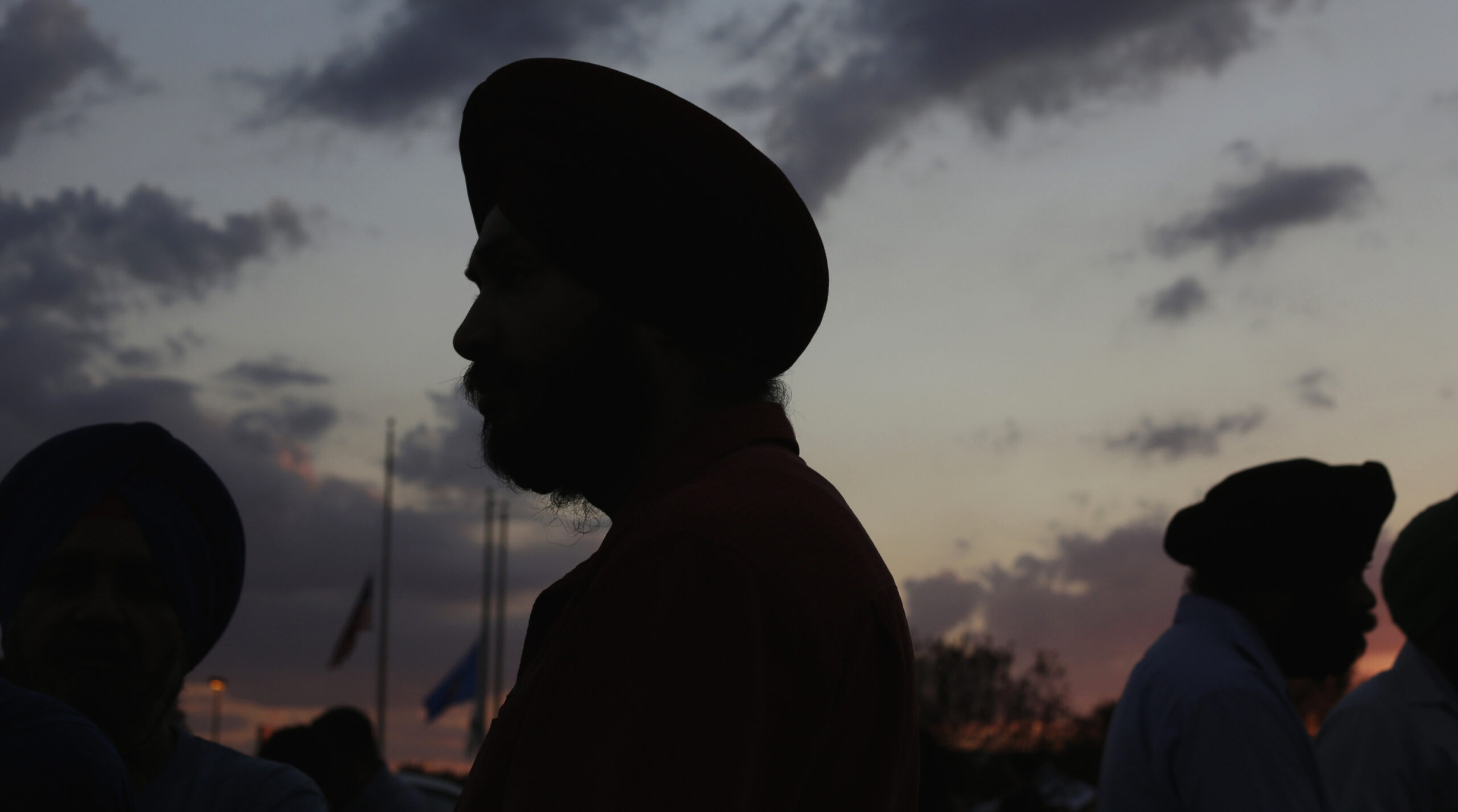 Flags fly at half-staff as Sikhs prepare for a vigil in Oak Creek, Wis., Aug. 7, 2012. (Reuters/John Gress)