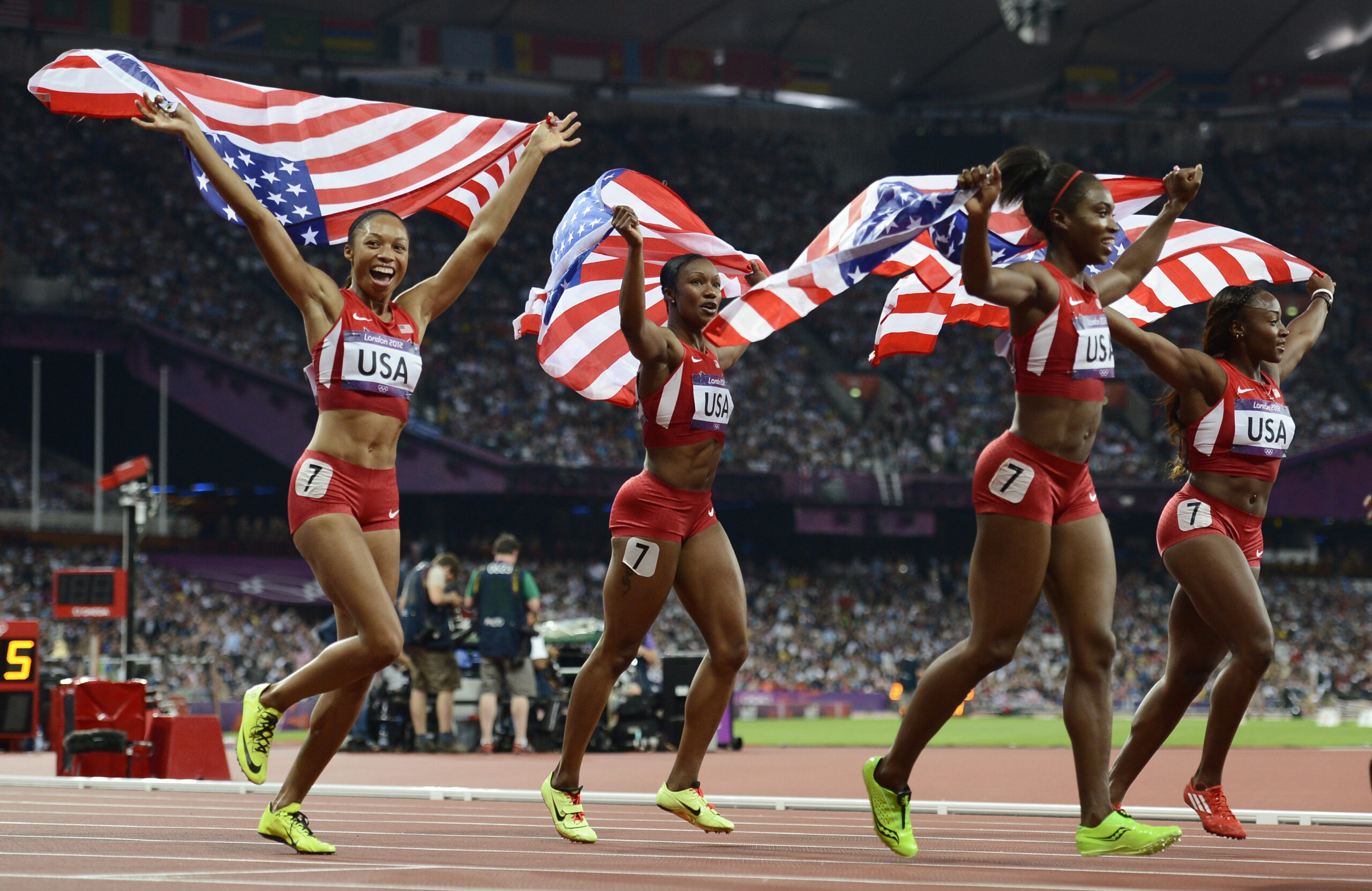 Allyson Felix (L-R), Carmelita Jeter, Tianna Madison and Bianca Knight of the U.S. celebrate after winning gold in the women's 4x100m relay. (Reuters/Dylan Martinez)