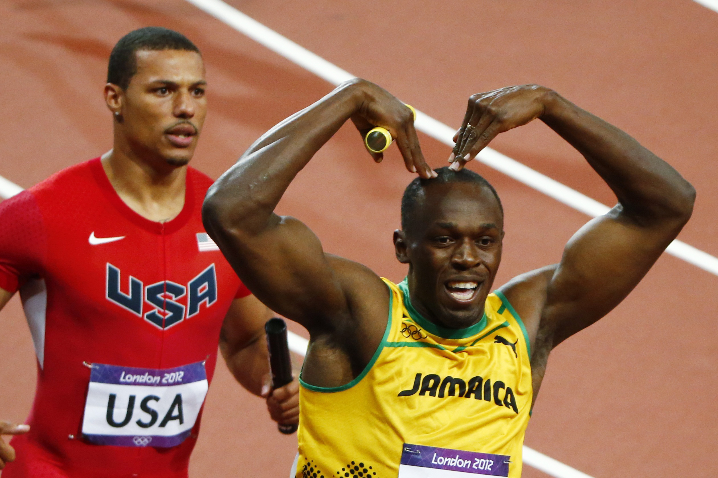 Jamaica's Usain Bolt celebrates after he won gold ahead of Ryan Bailey of the U.S. in the men's 4x100m relay final at the London 2012 Olympic Games at the Olympic Stadium August 11, 2012. The Jamaican team set a new world record of 36.84 seconds. REUTERS/David Gray (BRITAIN  - Tags: OLYMPICS SPORT ATHLETICS) (Reuters/David Gray)