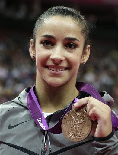 U.S. gymnast Alexandra Raisman displays her bronze medal for the balance beam during the artistic gymnastics women's apparatus finals at the 2012 Summer Olympics, Tuesday, Aug. 7, 2012, in London. (AP Photo/Gregory Bull) (AP)