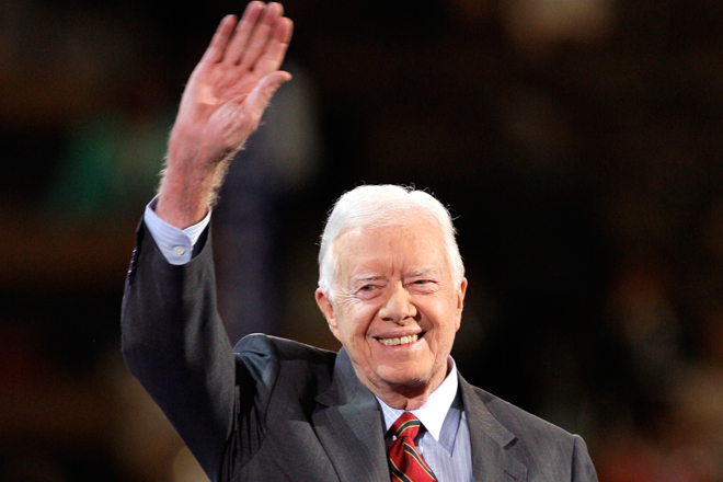 Former President Jimmy Carter waves to the crowd as he goes on stage at the Democratic National Convention in Denver on Aug. 25, 2008. (AP/Paul Sancya)