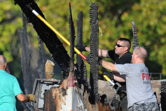 Firefighters maneuver debris following a fire at the Islamic Society of Joplin, Mo. (AP/T. Rob Brown)
