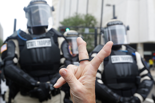A demonstrator protesting the Republican National Convention in Tampa confronts police. (AP/Patrick Semansky)