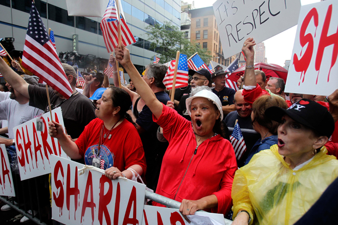 People participate in a rally against a proposed mosque and Islamic community center near Ground Zero in New York. (AP/Seth Wenig)