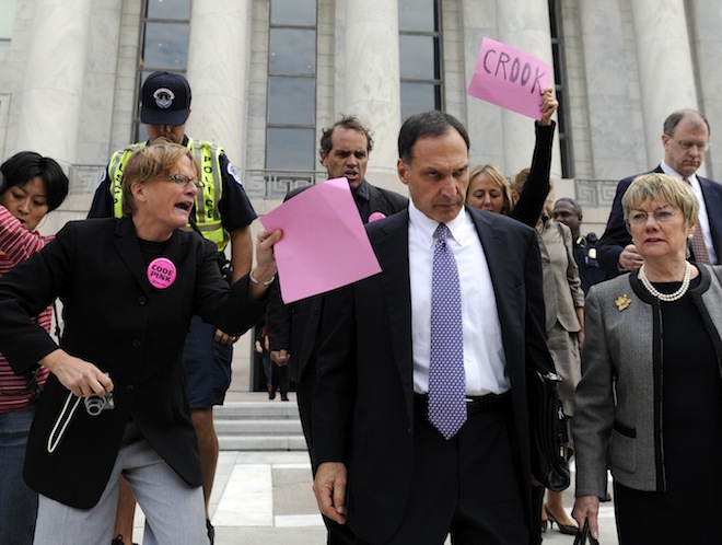 In this Oct. 6, 2008, file photo, Lehman Brothers Holdings Inc. Chief Executive Richard S. Fuld Jr., wearing tie, is heckled by protesters as he leaves Capitol Hill in Washington after testify before the House Oversight and Government Reform Committee on the collapse of Lehman Brothers. (AP/Susan Walsh)