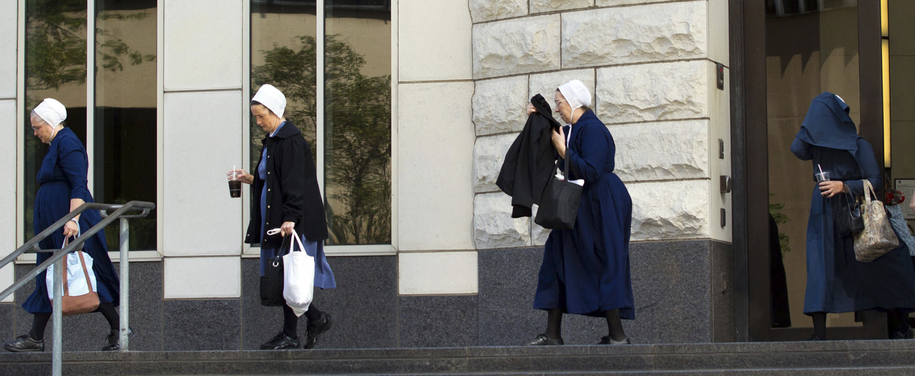 Amish women exit the U.S. Federal Courthouse in Cleveland on Thursday, Sept. 20, 2012. (AP/Scott R. Galvin)