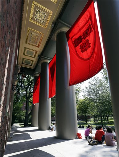 People sit on the campus of Harvard University in Cambridge, Mass. Thursday, Aug. 30, 2012. (AP/Elise Amendola)